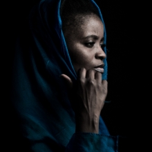 Black woman with blue drape